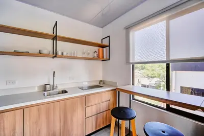 a kitchen with a counter and a sink and a window at Modern Caribbean Studio - Roosevelt in Puerto Limón