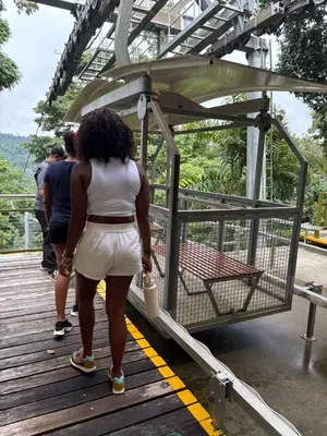 a woman is standing on a wooden bridge at Modern Caribbean Studio - Roosevelt in Puerto Limón