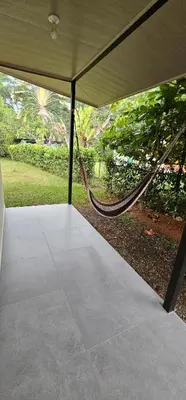 a porch with a hammock in a tent at Casa Eden Near Manuel Antonio in Manuel Antonio