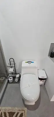a bathroom with a white toilet in a room at Casa Eden Near Manuel Antonio in Manuel Antonio