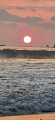 a sunset on the beach with the ocean at Casa Eden Near Manuel Antonio in Manuel Antonio