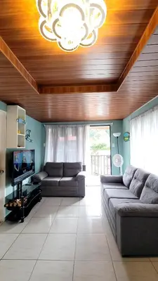 a living room with two couches and a chandelier at Marlin Vacations Home in Savegre