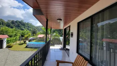 a balcony with a view of a pool at Marlin Vacations Home in Savegre