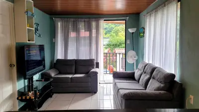 a living room with two couches and a television at Marlin Vacations Home in Savegre