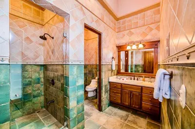 a bathroom with a shower and a sink and a toilet at Palacio Tropical in Puntarenas