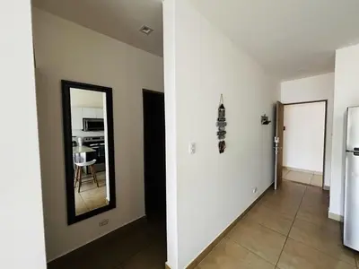 a hallway with a mirror and a dining room at Beachfront Getaway, AC, Pools and Sunset Views in Bejuco