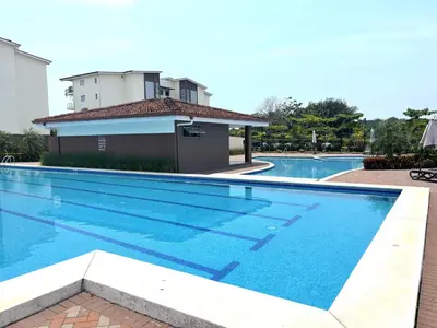 a swimming pool in front of a house at Beachfront Getaway, AC, Pools and Sunset Views in Bejuco