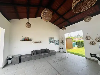 a living room with a couch and a ceiling at Beachfront Getaway, AC, Pools and Sunset Views in Bejuco