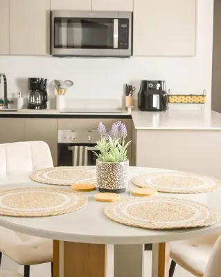a kitchen with a table with four plates on it at Gaia Retreat - Núcleo Sabana in San José