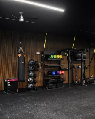 a fight room with a punching bag hanging from a wall at Gaia Retreat - Núcleo Sabana in San José