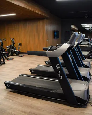 a row of treadmills in a gym at Gaia Retreat - Núcleo Sabana in San José