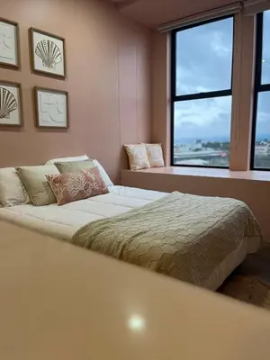 a bedroom with a bed and a large window at Vista Aqua Escalante in San José