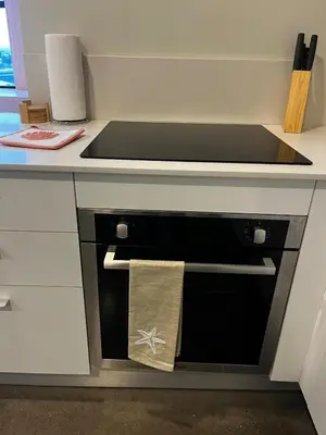 a kitchen with a black oven with a towel on it at Vista Aqua Escalante in San José