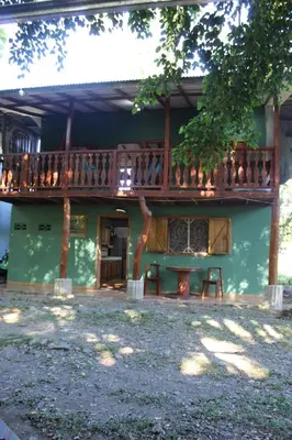 a house with a deck on the side of it at Brisas del Caribe 3 in Tapantí