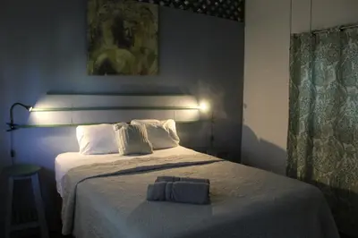 a bedroom with a bed with a towel on it at Brisas del Caribe 3 in Tapantí