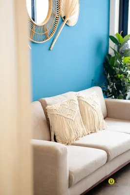 a couch with a pillow on it in a living room at Catorce Urbano in San José