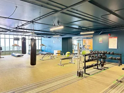 a gym with two punching bags and weights at Catorce Urbano in San José