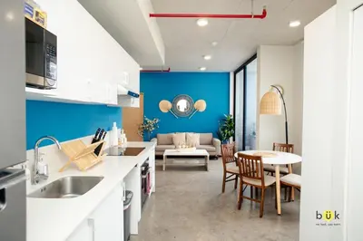 a kitchen and living room with a table and a couch at Catorce Urbano in San José