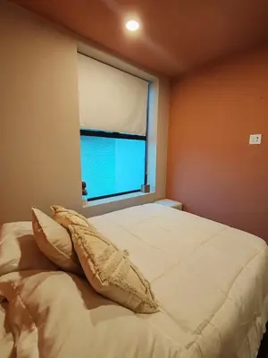 a bedroom with a large bed with a window at Horizonte 28 Escalante in San José
