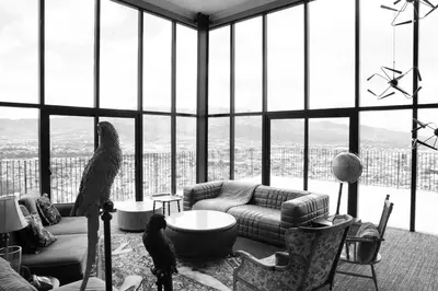 a living room with a couch and large windows at Horizonte 28 Escalante in San José