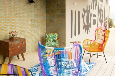 a room with colorful chairs and a table and a chest at Horizonte 28 Escalante in San José