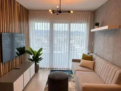 a living room with a couch and a large window at Luxury 1BR Condo Stunning Views in San José