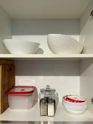 a shelf with bowls and other items in a kitchen at Luxury 1BR Condo Stunning Views in San José