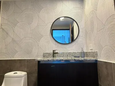 a bathroom with a mirror and a sink and a toilet at Luxury 1BR Condo Stunning Views in San José