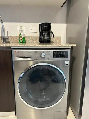 a washing machine in a kitchen next to a counter at Luxury 1BR Condo Stunning Views in San José