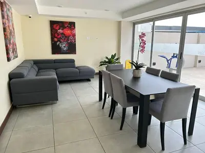 a living room with a table and a couch at Luxury 1BR Condo Stunning Views in San José
