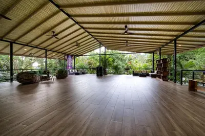 a large room with a wooden floor and large windows at Synergy Costa Rica in Uvita