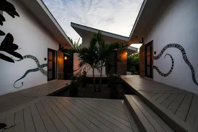a house with a wooden walkway with a window at Synergy Costa Rica in Uvita