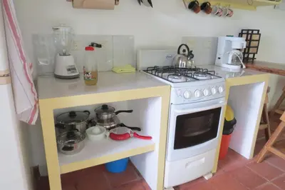 a small kitchen with a stove and a counter top at Apartamento Karibu in Manuel Antonio