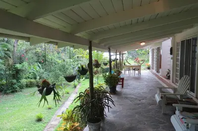 a porch of a house with potted plants at Apartamento Karibu in Manuel Antonio