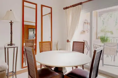 a dining room with a white table and chairs at Casa del Mar - Veranda Retreat Pool and Balcony in Herradura
