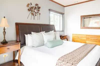 a bedroom with a white bed with a blue pillow on it at Casa del Mar - Veranda Retreat Pool and Balcony in Herradura