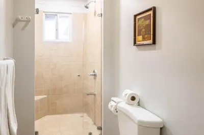 a bathroom with a shower stall and a toilet at Casa del Mar - Veranda Retreat Pool and Balcony in Herradura