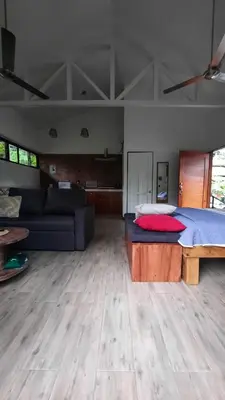a living room with a bed and a couch at Casa Caladium in Manuel Antonio