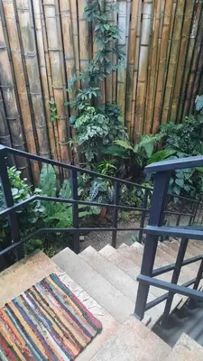 a balcony with a fence and a bench and plants at Casa Caladium in Manuel Antonio