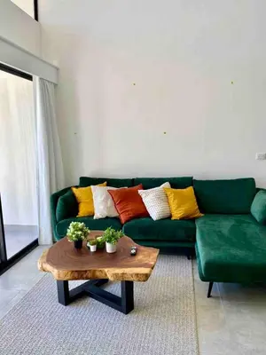 a living room with a green couch and a coffee table at Walk to Private Beach Luxury amidst Nature in Puntarenas