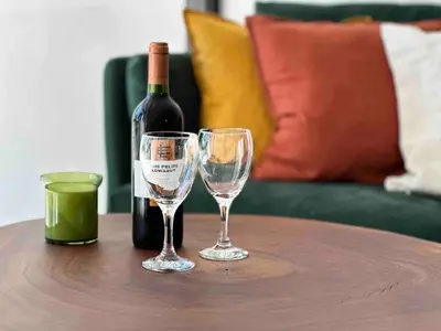 a bottle of wine and two wine glasses on a table at Walk to Private Beach Luxury amidst Nature in Puntarenas