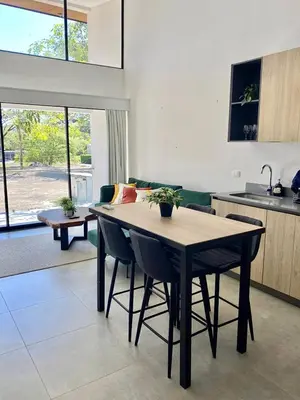 a kitchen and dining room with a table and chairs at Walk to Private Beach Luxury amidst Nature in Puntarenas