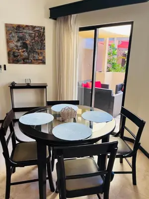 a dining room with a table and chairs and a living room at The Cove Door 15 and 16 Upper & Lower Unit in Ocotal