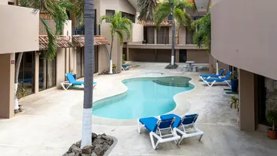 an overhead view of the pool at a hotel with chairs and a palm tree at The Cove Door 15 and 16 Upper & Lower Unit in Ocotal