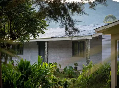 an old white house with a solar roof at Valmonte Coffee Farm in Santa María