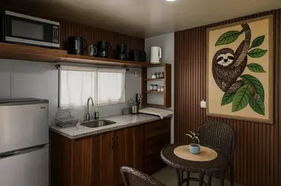 a kitchen with a monkey painting on the wall at Selva with a view of the volcano, fast wifi, TV in Fortuna