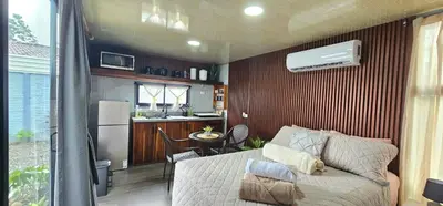 a living room with a couch and a kitchen at Selva with a view of the volcano, fast wifi, TV in Fortuna