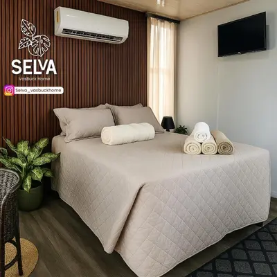 a bedroom with a bed with towels on it at Selva with a view of the volcano, fast wifi, TV in Fortuna