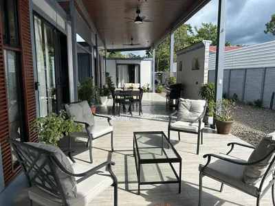a patio with chairs and a table and a dining room at Selva with a view of the volcano, fast wifi, TV in Fortuna