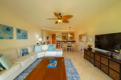 a living room with a white couch and a flat screen tv at Del Mar 2A 3 bdr Ocean View in Los Suenos in Herradura